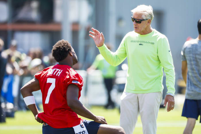 Seattle quarterback Geno Smith and coach Pete Carroll at training camp.